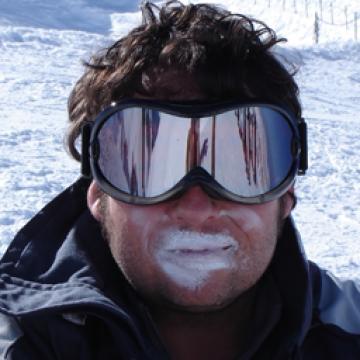 Man with sports sunglasses in snow