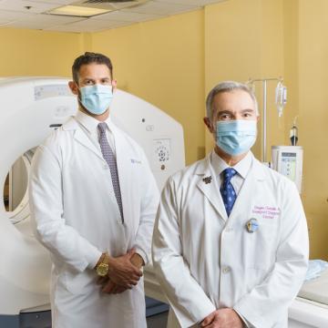 Two doctors standing by a treatment device with confidence