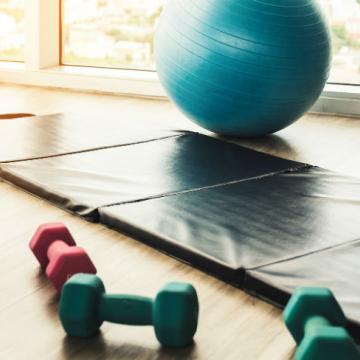 Spacious gymnasium with various fitness equipment neatly arranged.