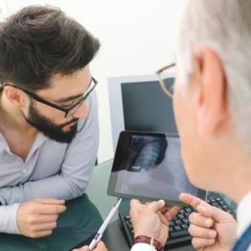 Doctor discussing scanning results with a young man