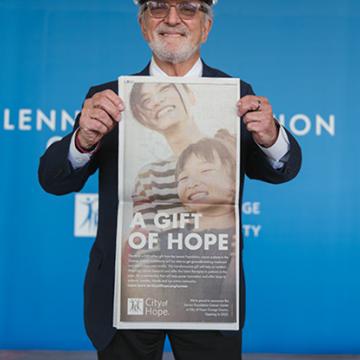 At a Lennar giving event, a person demonstrating the "A gift of hope" poster
