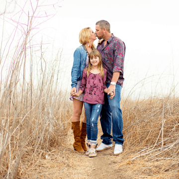 Cancer survivor Gary Heyer, his wife, and daughter celebrate love and life in a vibrant tapestry of wildflowers
