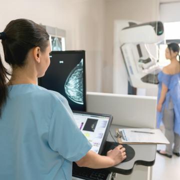  Nurse giving a mammogram exam to an adult patient at the hospital