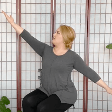 Occupational Therapist demonstrates de-stressing yoga, stretching arms diagonally to alleviate pain