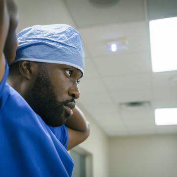 Black male surgeon preparing for a procedure