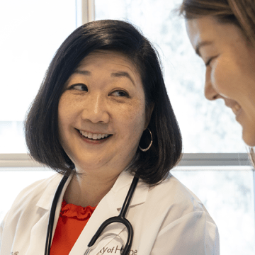Doctor Janet Yoon smiling with a patient