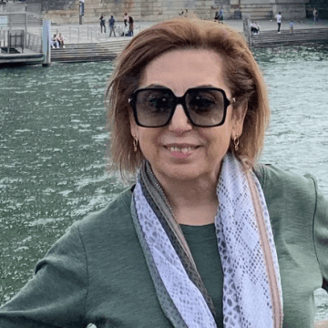 City of Hope patient Ida Yaghoobians smiling on a bridge