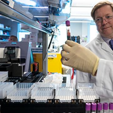 Stephen Gruber, M.D., Ph.D., reviewing bio samples | Gruber Lab | City of Hope