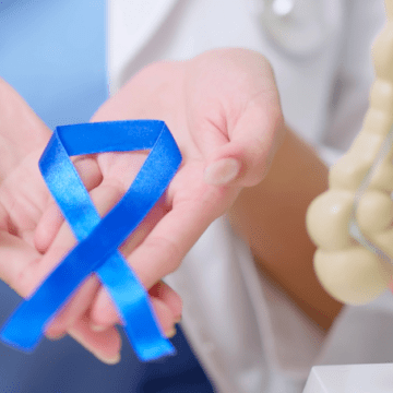 A nurse holds a colon cancer ribbon