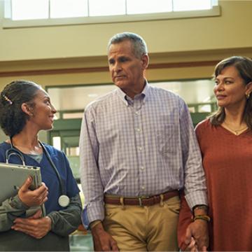 Nurse guiding patient and family