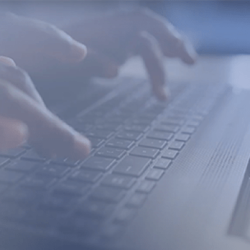 A telehealth patient types on a keyboard