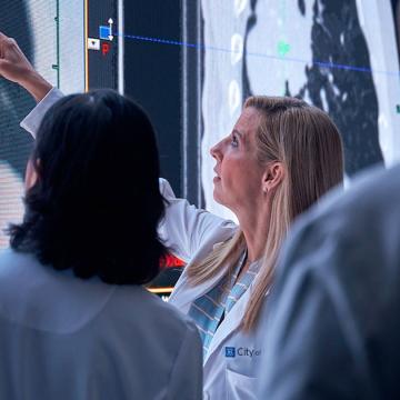 image of three doctors reviewing charts on a wall