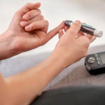 image of a person using an insulin tester