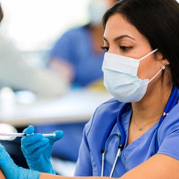 image of a doctor giving a patient a shot
