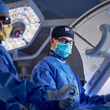Jonathan Kessler, M.D., and Ryan Lansangan in the OR