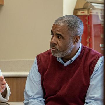 image of a male doctor explaining something to a man