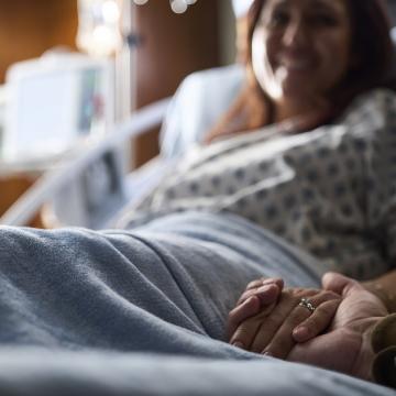slightly blurred image of a young woman in a hospital bed