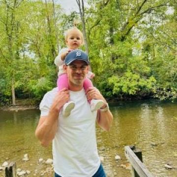 Man carrying daughter on his shoulders
