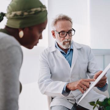 image of a doctor explaining a chart to a woman in the foreground