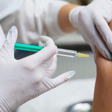 Healthcare professional giving patient a shot in the arm