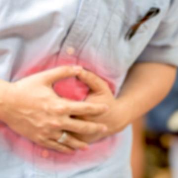 Person holding their stomach in pain