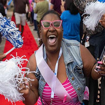 Cancer survivor celebrating with pom pom