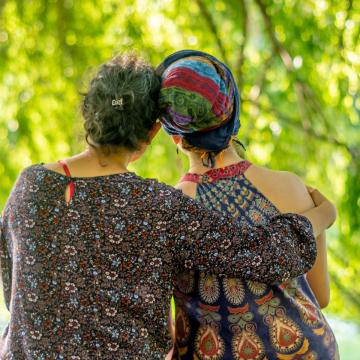 Two female cancer survivors hugging and comforting each other