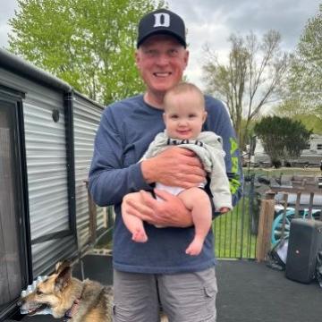 Les Balaszek and grandbaby posing for a picture