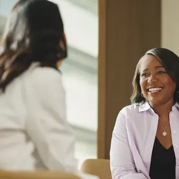 Breast cancer patient Kommah McDowell speaks with Irene Kang, M.D.