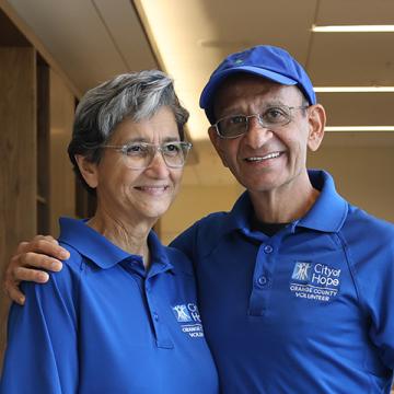 Parizad and grateful patient Seth in City of Hope Orange County volunteer shirts