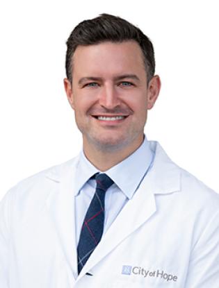 Adam-Rock-Headshot-White-Coat-315x340