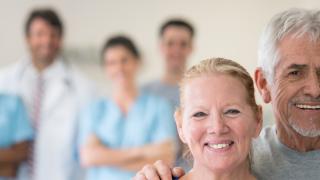 couple at a physical rehabilitation clinic looking at the camera smiling