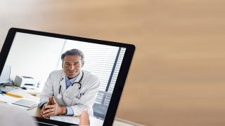 Patient Holding Tablet with Physician on It