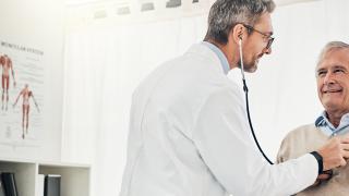 Doctor checking his patient's heart