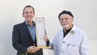 Ted Schwartz and Doctor Steven Rosen holding a recognition plaque for the Ted Schwartz Family gift 