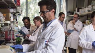 Fueger Lab Team Group in lab coats together