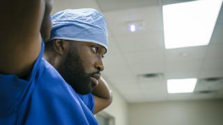 Black male surgeon preparing for a procedure