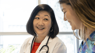 Doctor Janet Yoon smiling with a patient