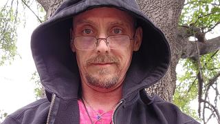 Michael Evrard in a hoodie