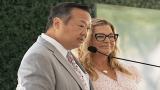 Patient Diane Miller and Dr. Edward Kim at lecturn