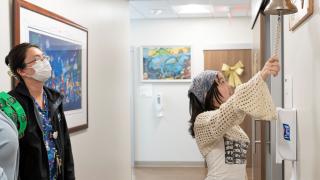 A pediatric cancer patient rings the bell at City of Hope to celebrate being cancer free.