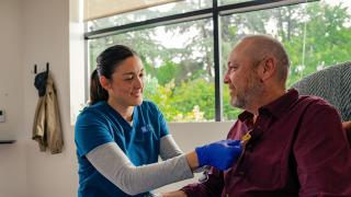 Nurse assisting patient