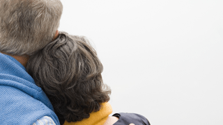 Couple hugging and facing away from the camera