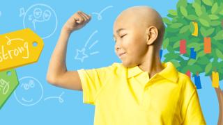 A pediatric cancer patient flexes his bicep in a show of strength