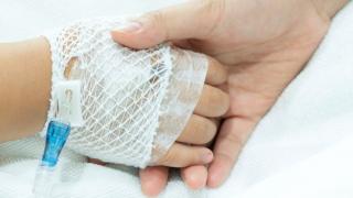 Nurse holding the hand of a patient