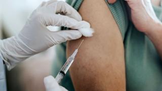 image of person receiving a shot in the arm