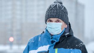 image of a person wearing a parka and a face mask in snowy weather