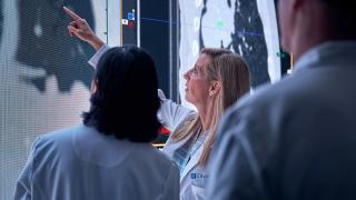 image of three doctors reviewing charts on a wall