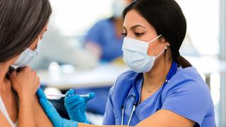 image of a doctor giving a patient a shot