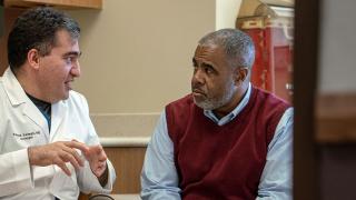 image of a male doctor explaining something to a man
